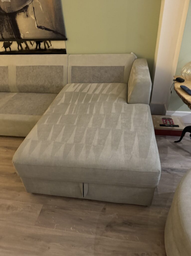 Light grey fabric chaise lounge professionally cleaned and restored with a fresh, even finish.