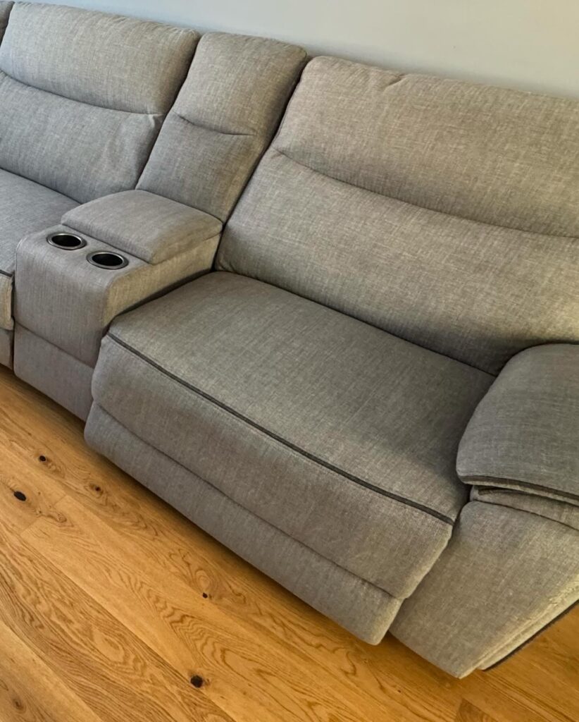 Light grey fabric recliner chair with a clean, refreshed appearance following upholstery cleaning and stain removal.