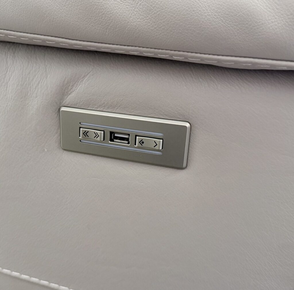Integrated USB charging and recliner control panel restored and fitted into a white leather sofa.