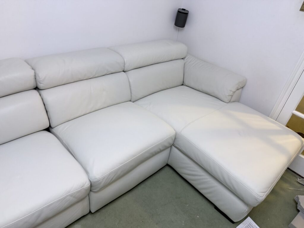 White leather chaise sofa repaired and restored to a clean, like-new condition.
